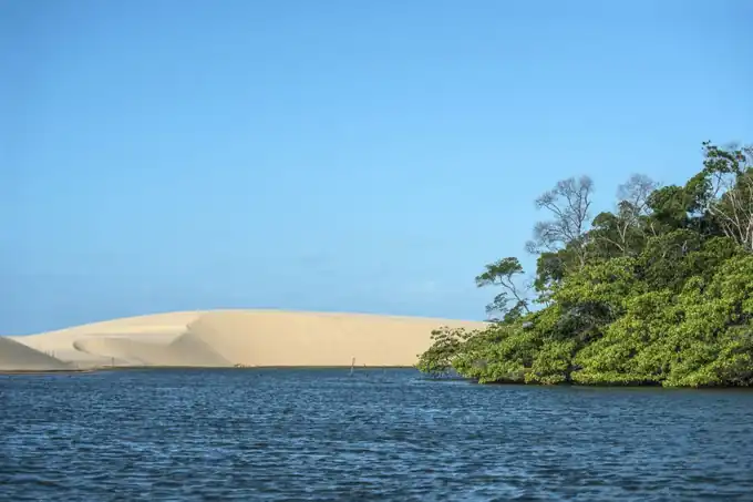 Lancha rápida cortando as águas do Delta do Parnaíba entre dunas e manguezais