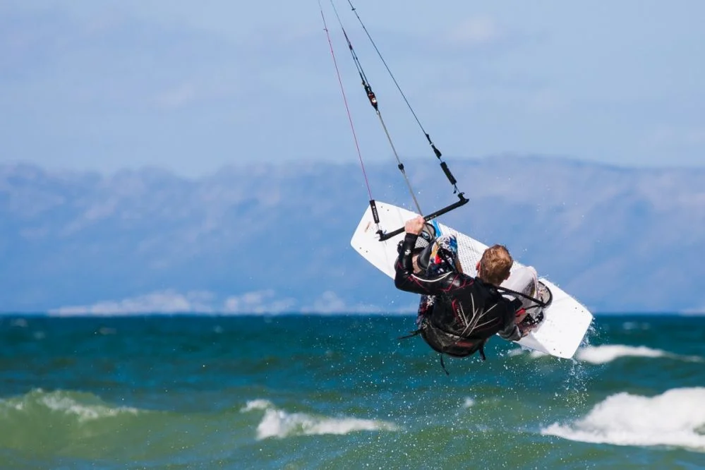 Praticante de kitesurf navegando em mar calmo com vento constante na praia de Barra Grande