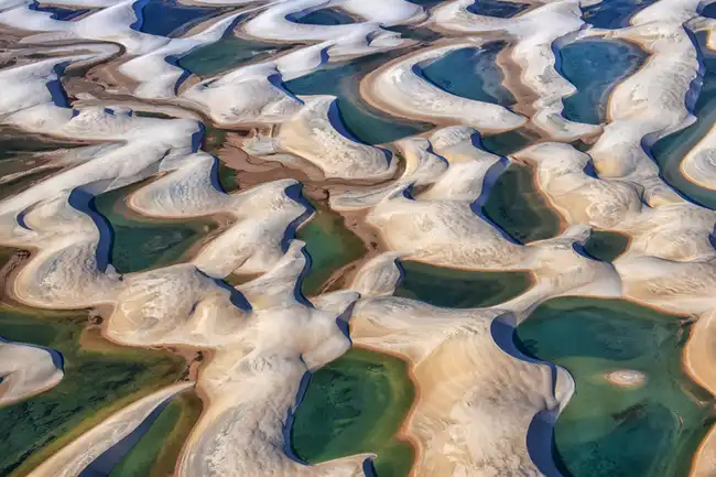Vastidão de dunas brancas e lagoas de água doce cristalina nos Lençóis Maranhenses